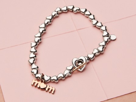 A Bracelet Wit The Charms M, Heart, M, Attached To It